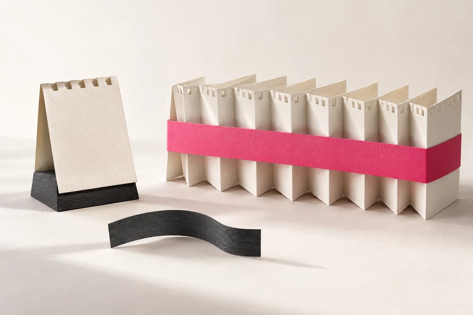 A single paper calendar leaf is compared with an accordion bundle tied by a ribbon.